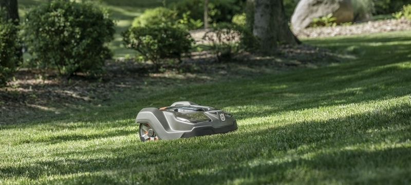 Robot Lawn Mowers Review 2026: Are Autonomous Mowers Worth the Investment? husqvarna automower 435x mowing a large backyard