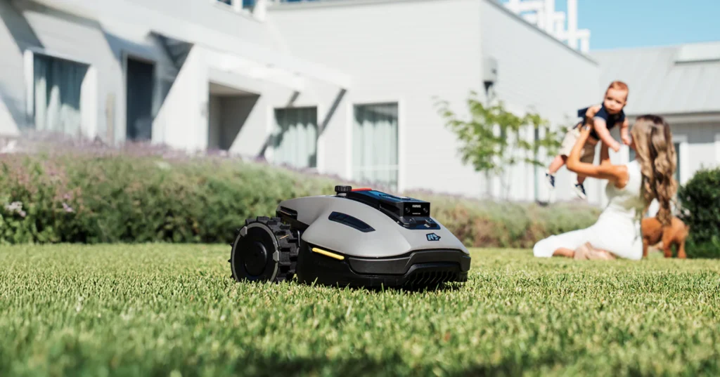 Robot Lawn Mowers Review 2026: Are Autonomous Mowers Worth the Investment? modern robot lawn mower operating on a suburban lawn