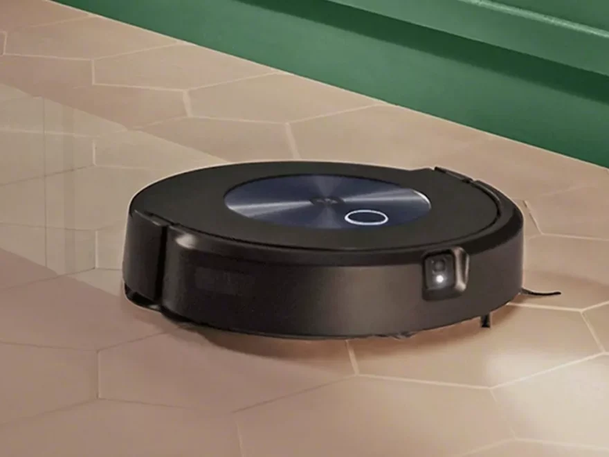 black robot vacuum cleaner on tiled floor.webp
